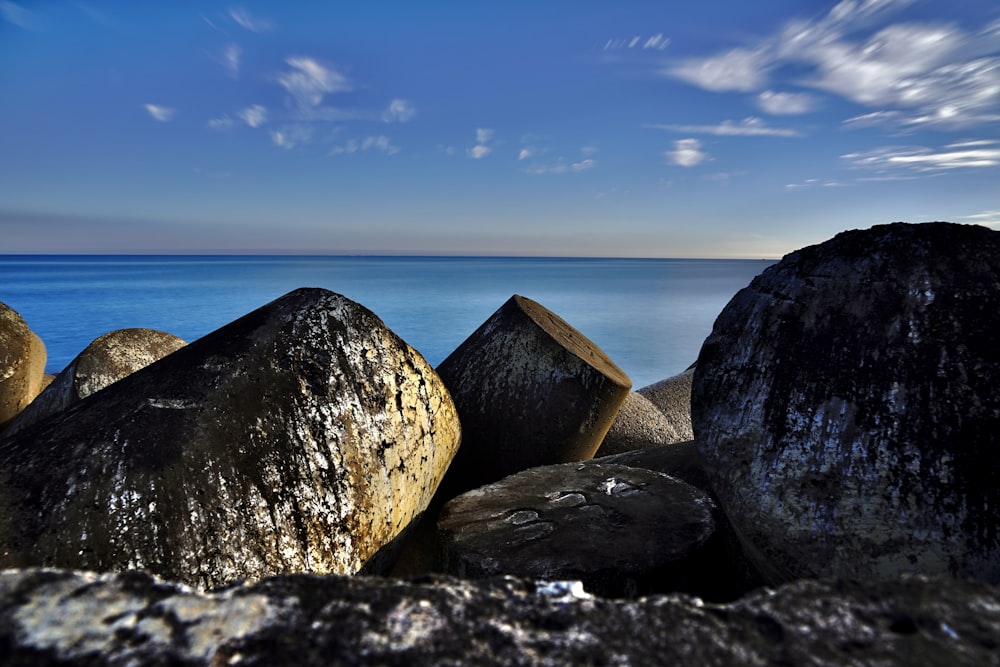 some rocks and water under a blue sky
