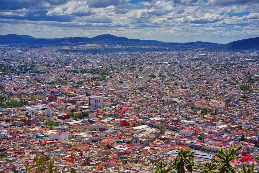 a view of a city with mountains in the background