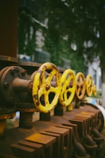 a row of yellow and black fire hydrants sitting next to each other