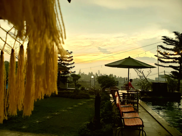 A cozy poolside scene with a brisamar backless bench and a colorful towel draped over it.