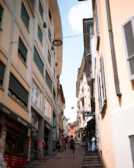 A friendly tour leader guiding a small group through a charming European street.