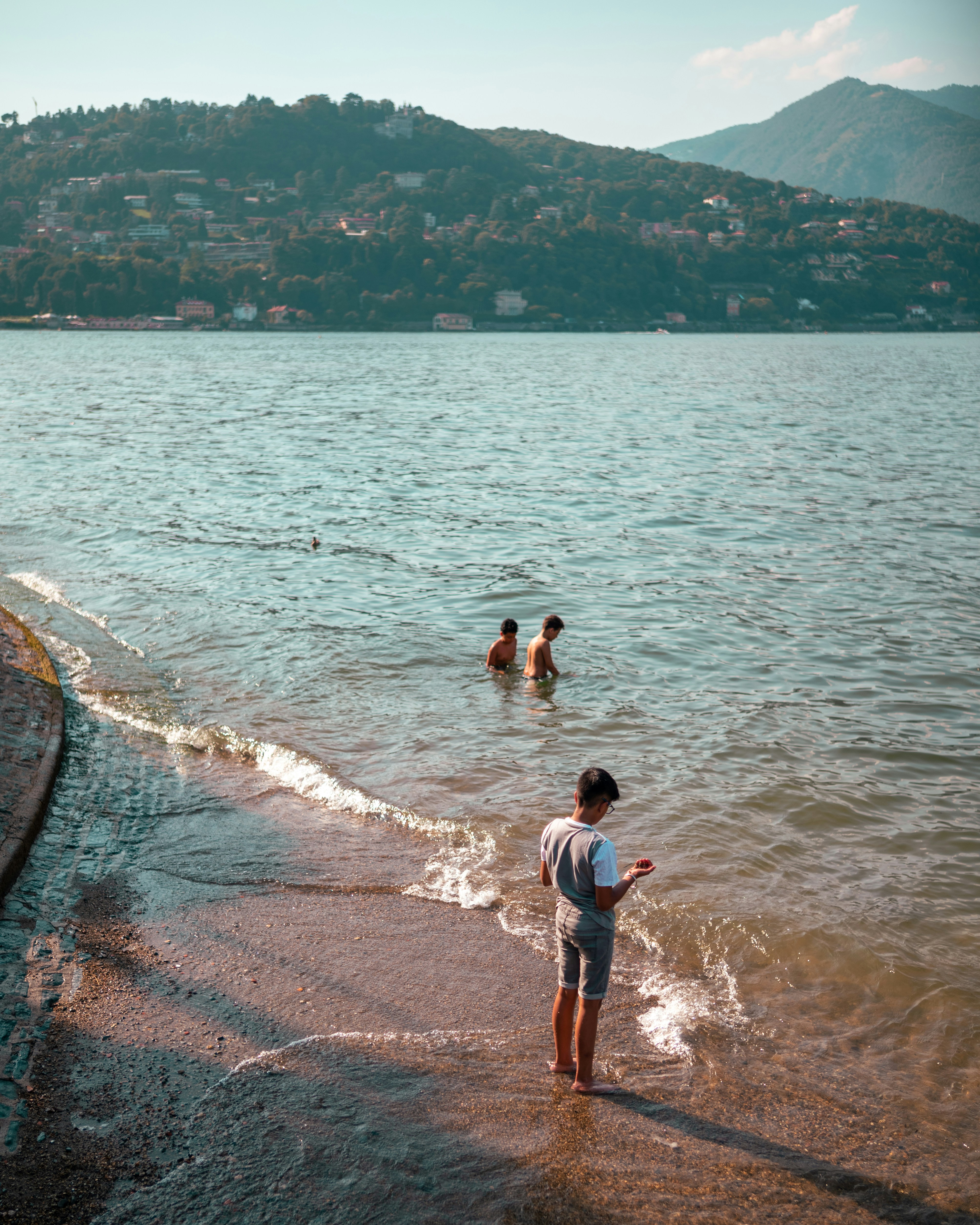a person standing in the water with a frisbee
