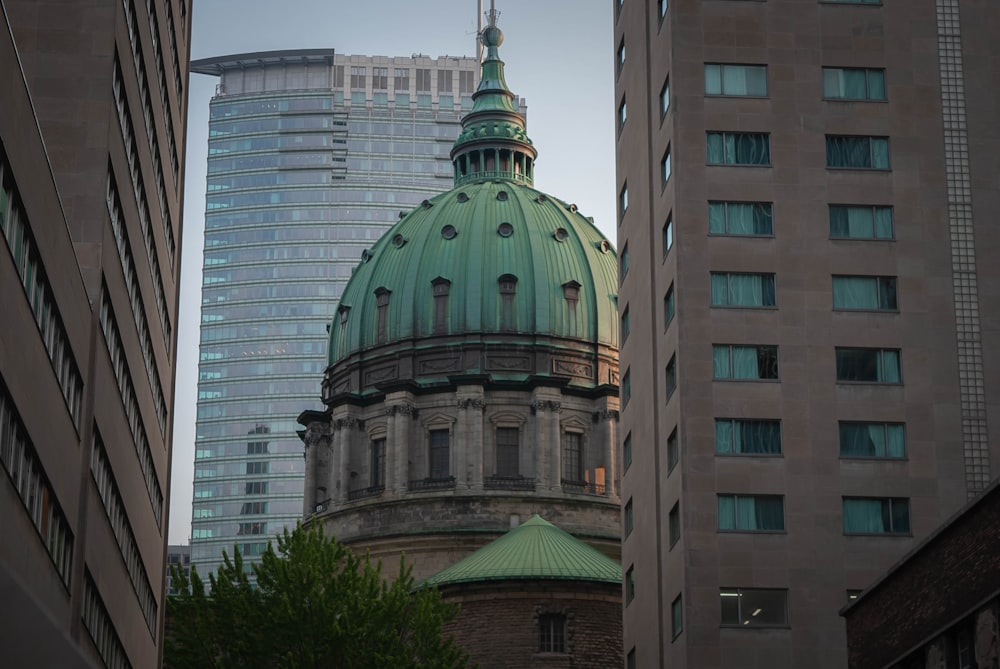 a green dome on top of a building in a city