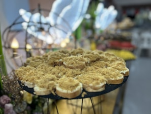A catering spread featuring various trays of chicken buns arranged beautifully for an event.