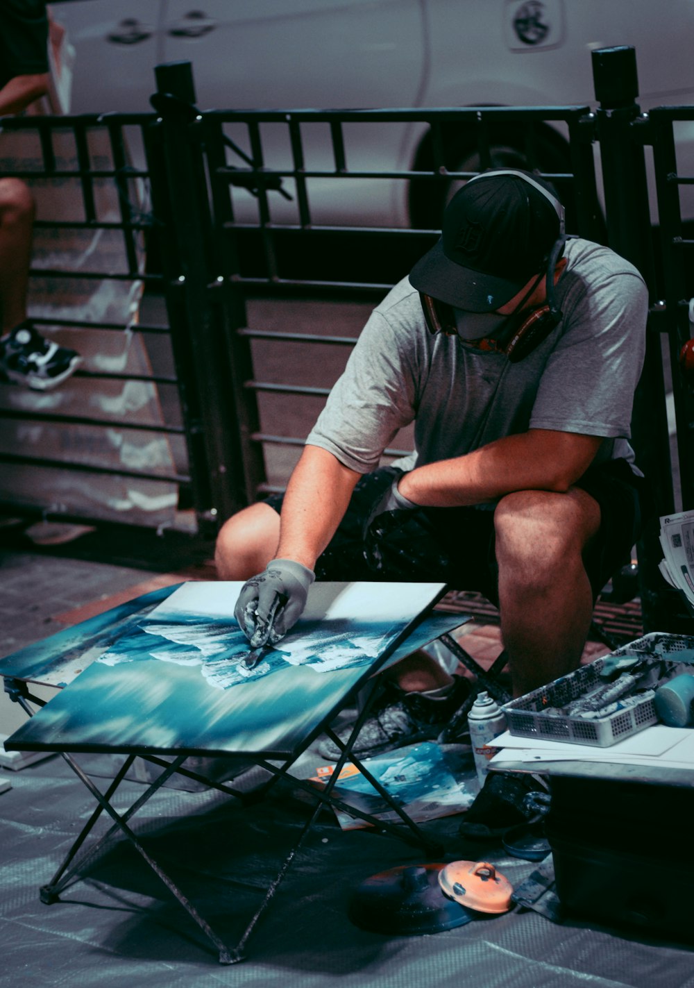 ein mann, der auf einem stuhl sitzt und ein bild malt