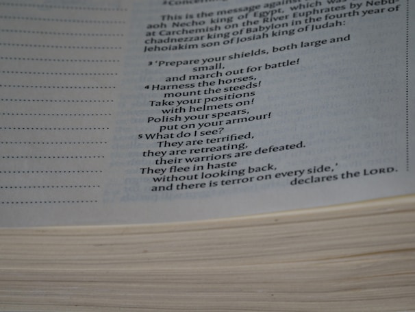Close-up of an open book showing a powerful passage about faith and courage in military history.