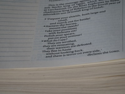 Close-up of hands flipping through a detailed military strategy book.