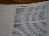 A close-up view of an open Bible page, showing text from the book of Jeremiah. The text appears in a column format with chapter and verse numbers visible. The page has a slightly blurred focus, with emphasis on specific verses of a religious text.