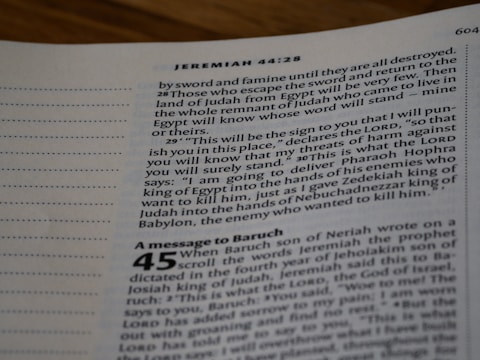 A close-up view of an open Bible page, showing text from the book of Jeremiah. The text appears in a column format with chapter and verse numbers visible. The page has a slightly blurred focus, with emphasis on specific verses of a religious text.