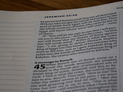 A close-up view of an open Bible page, showing text from the book of Jeremiah. The text appears in a column format with chapter and verse numbers visible. The page has a slightly blurred focus, with emphasis on specific verses of a religious text.