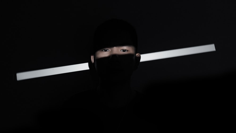 a person with their face obscured by a light