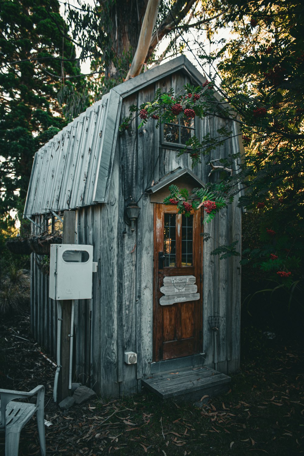 a small wooden shed with a window and a door