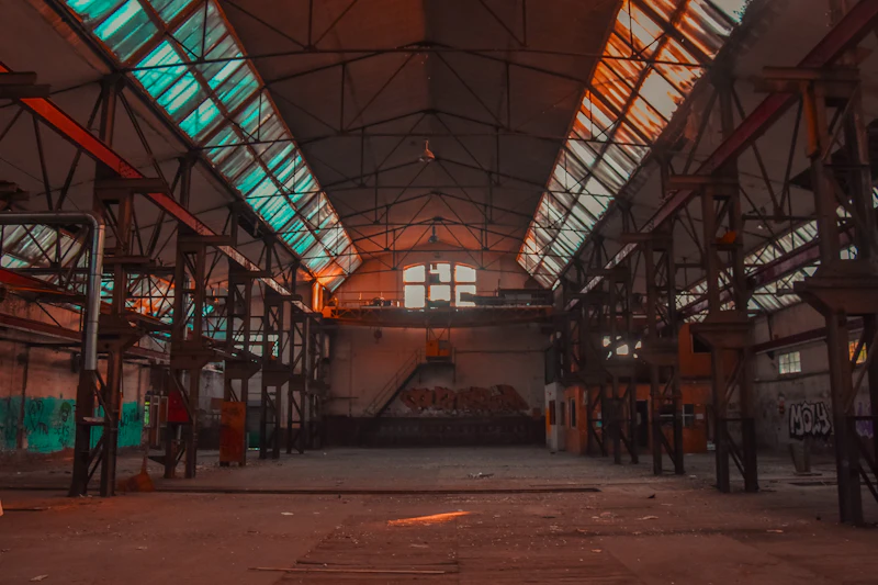 Large disused factory with rows of broken windows