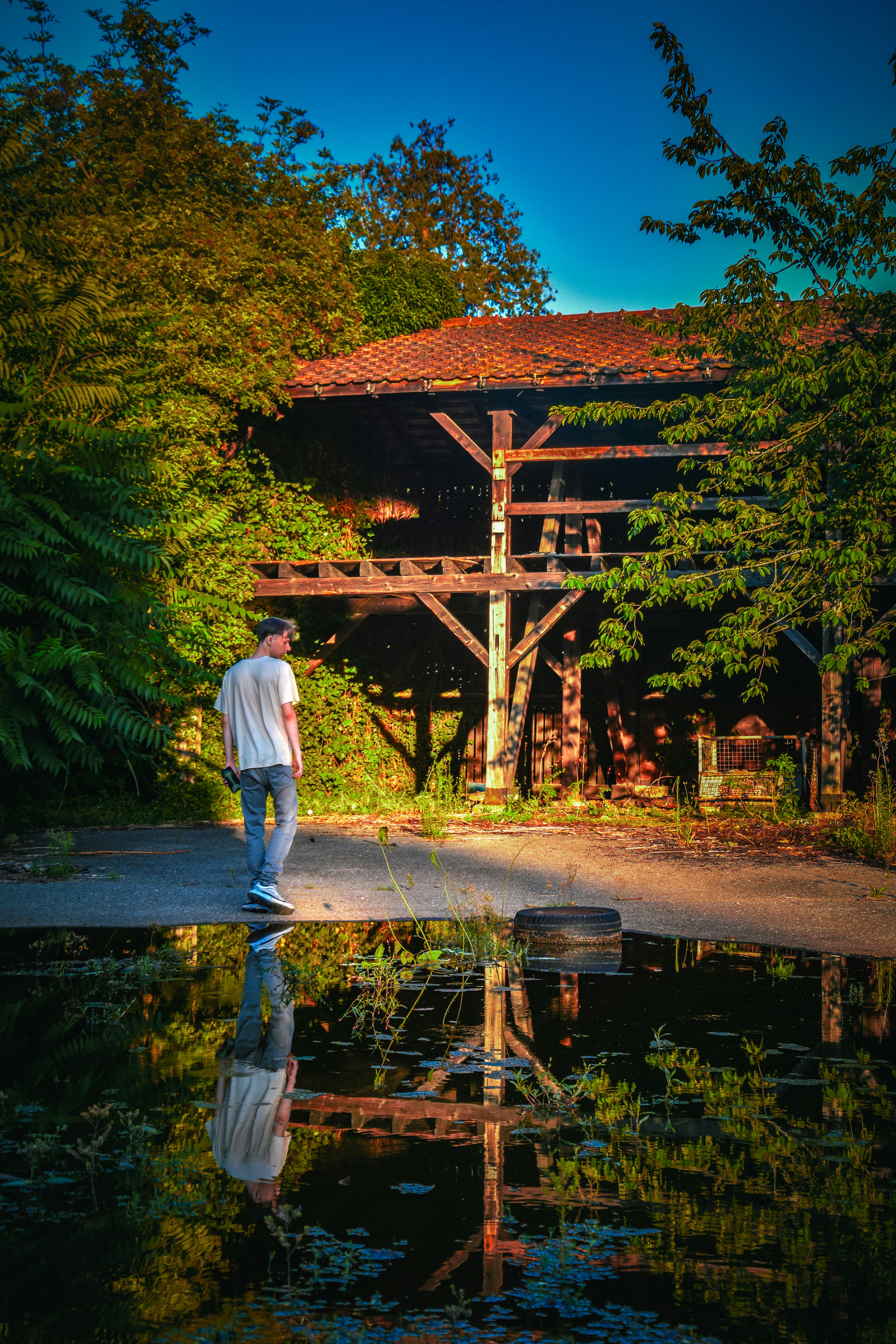 a man standing in front of a wooden structure