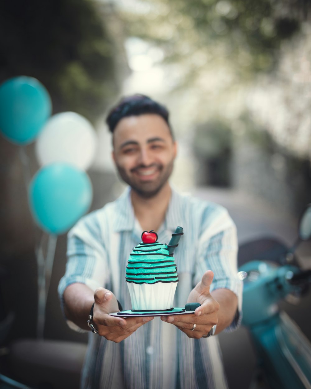 a man holding a plate with a cupcake on it