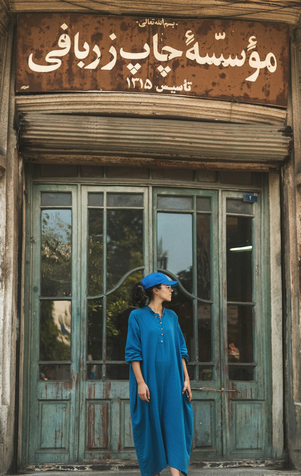 a woman standing in front of a building