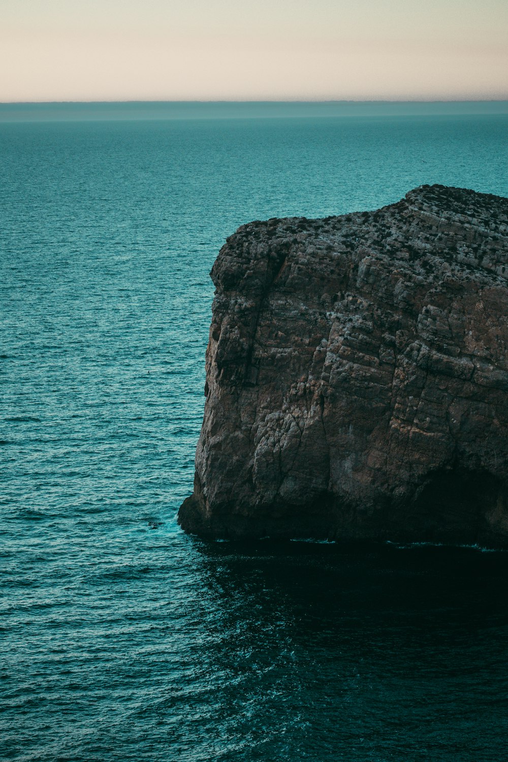 un gros rocher sortant de l’océan