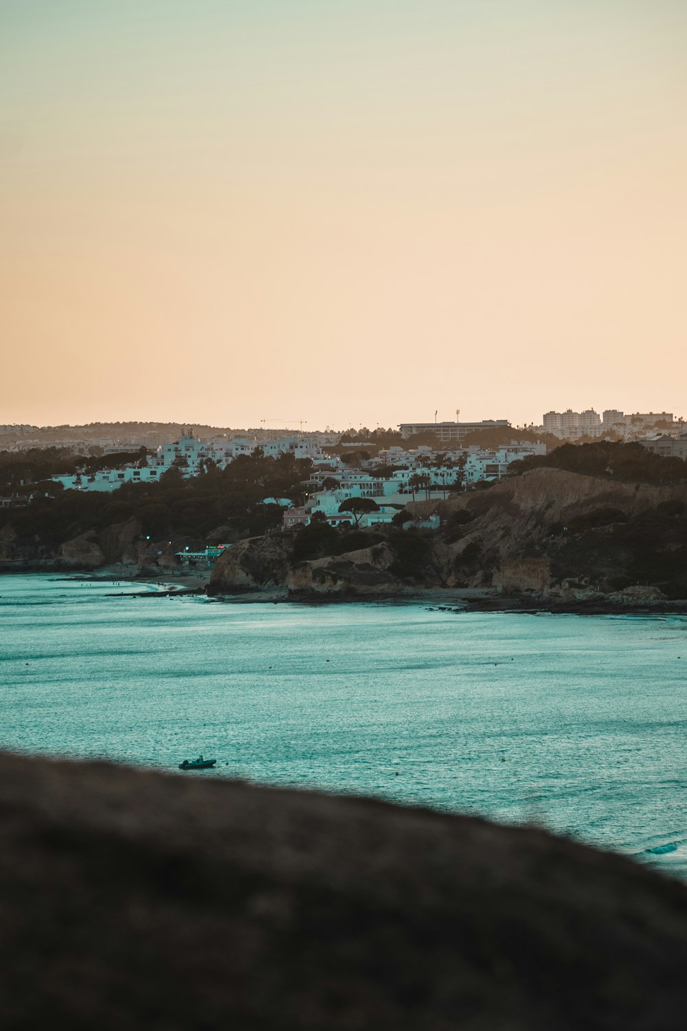 a body of water with a hill in the background