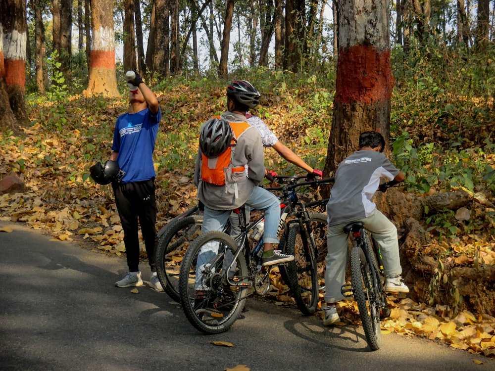 a group of people riding bikes down a road