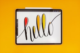a tablet with the word hello written on it