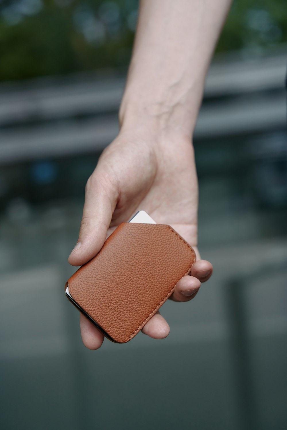 a person holding a wallet in their hand