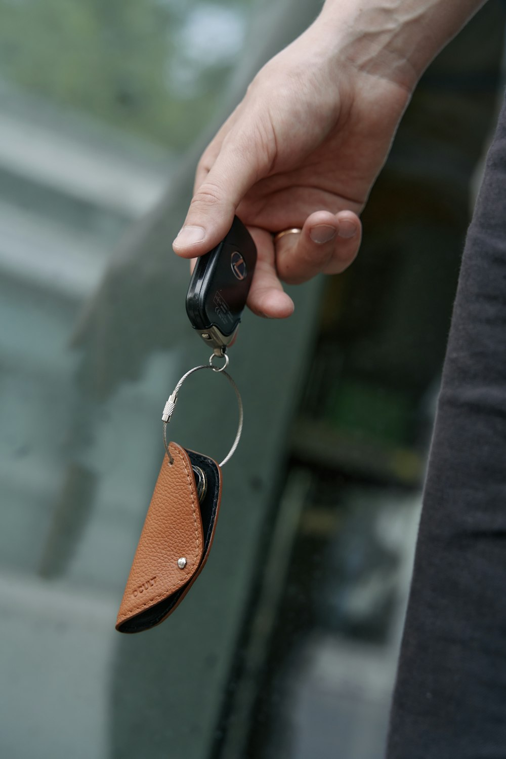 a person holding a car key in their hand