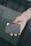 Close-up of a hand holding a cloned card with a blurred tech background.