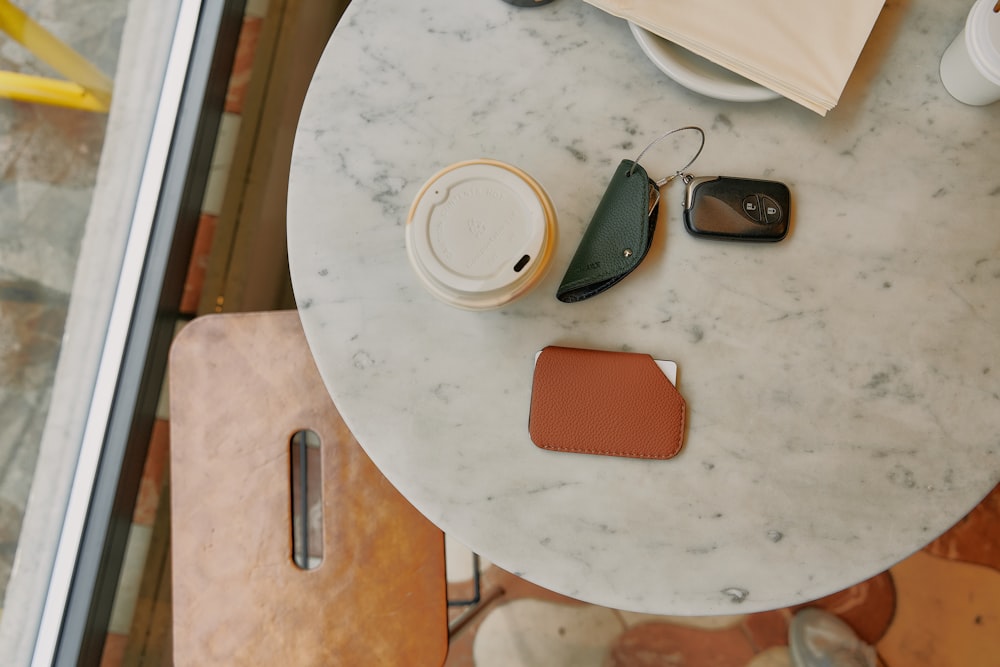 a table topped with a phone and a cup of coffee