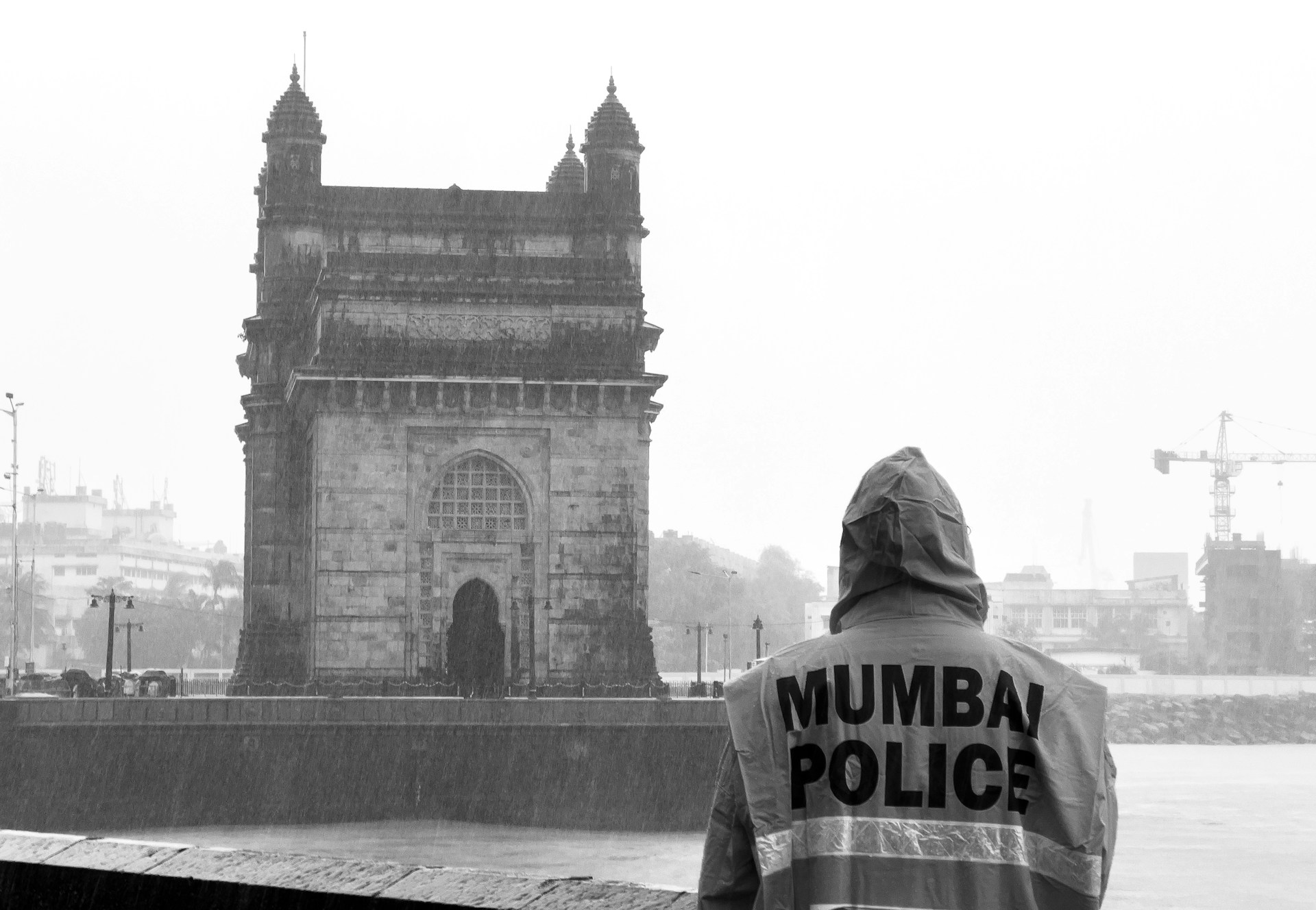 a man standing in front of a tall building