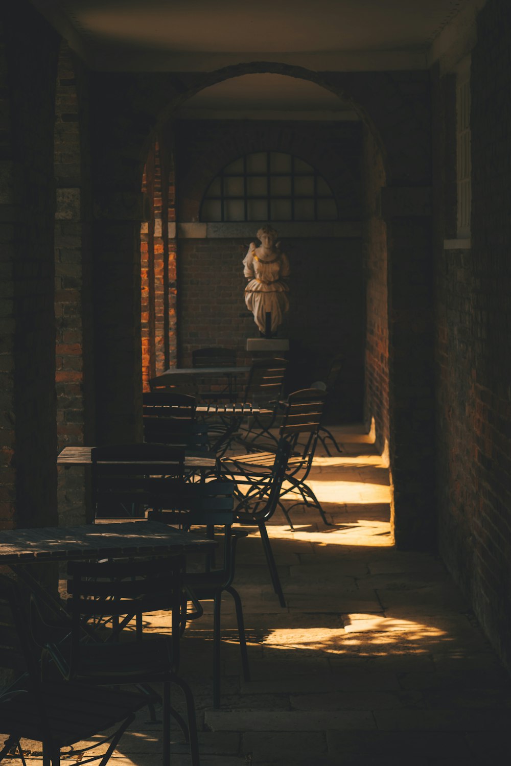 a table and chairs in a room with brick walls