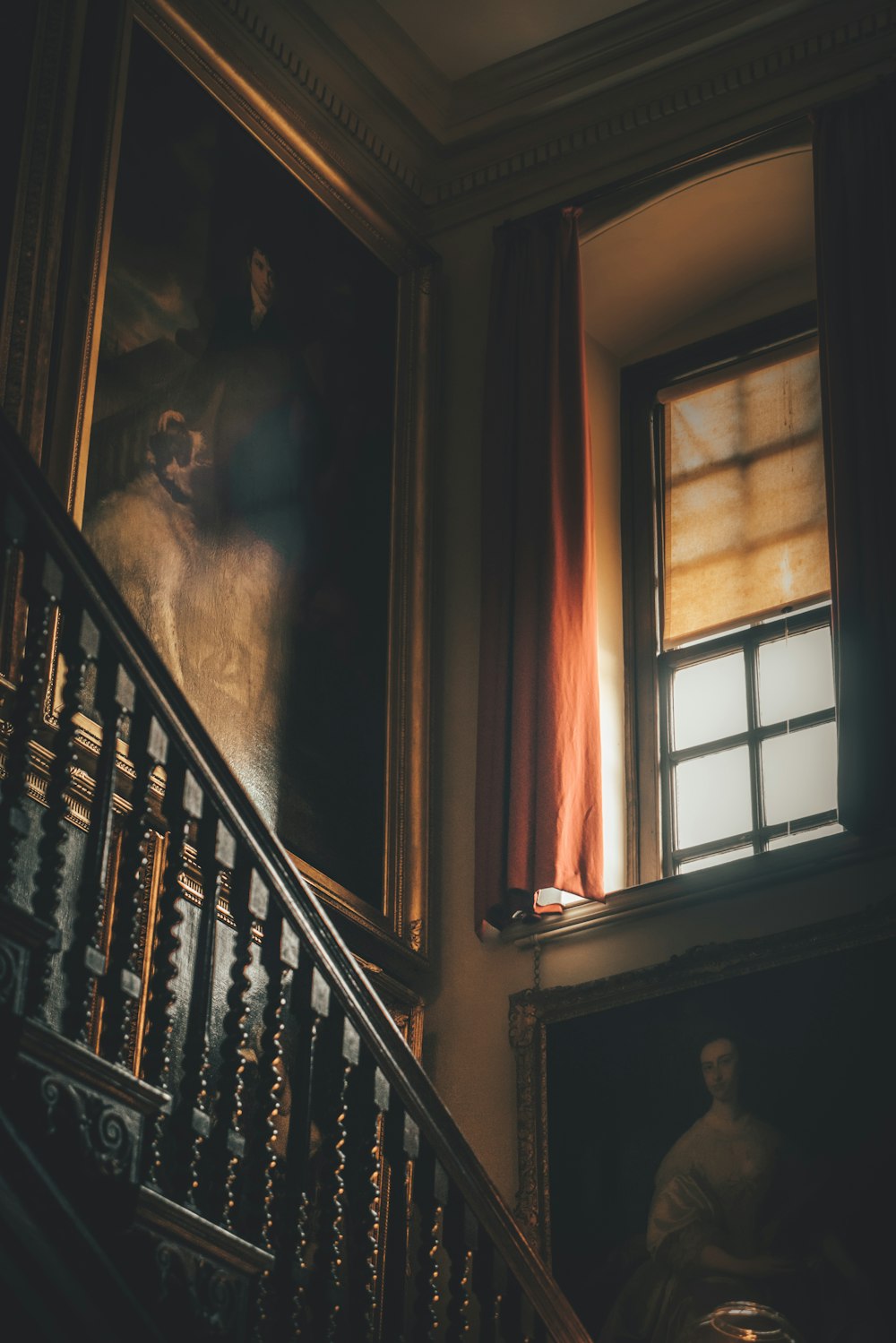 a staircase with a painting on the wall