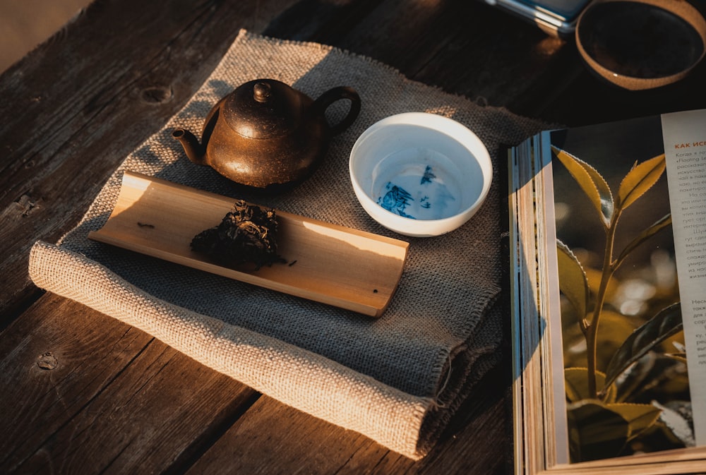 a tea pot and a book on a table