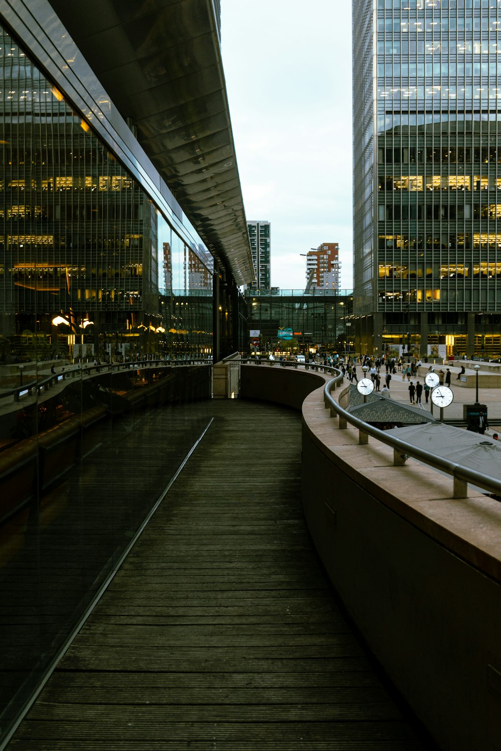 a walkway in a city with tall buildings in the background