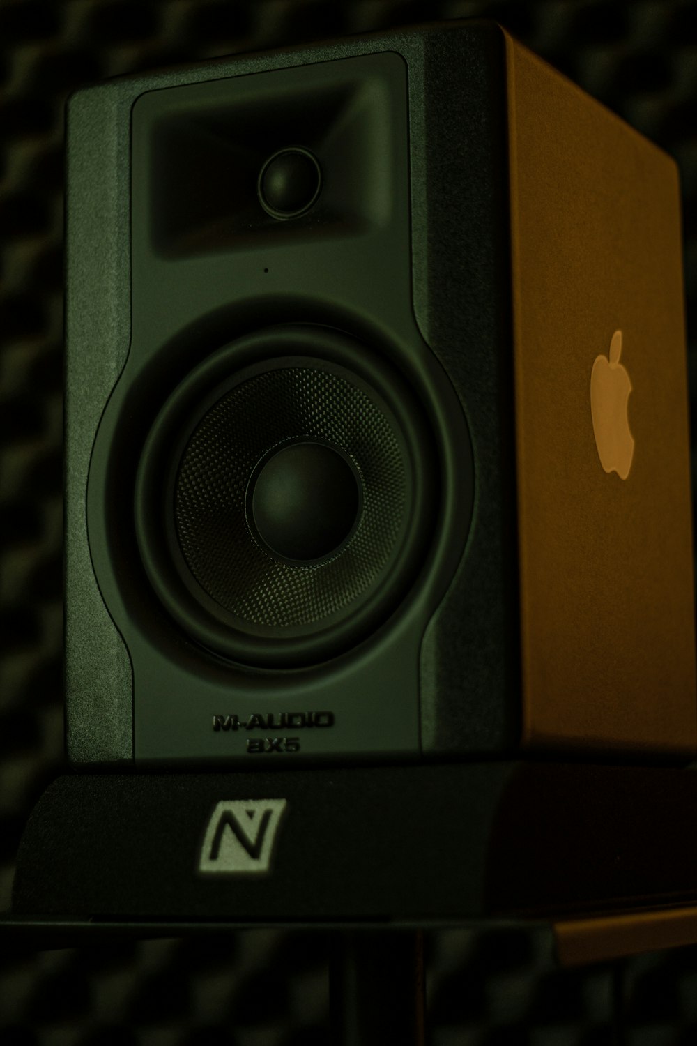 a computer speaker sitting on top of a table