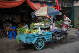 A refrigerated truck loaded with fresh vegetables departing from the warehouse.