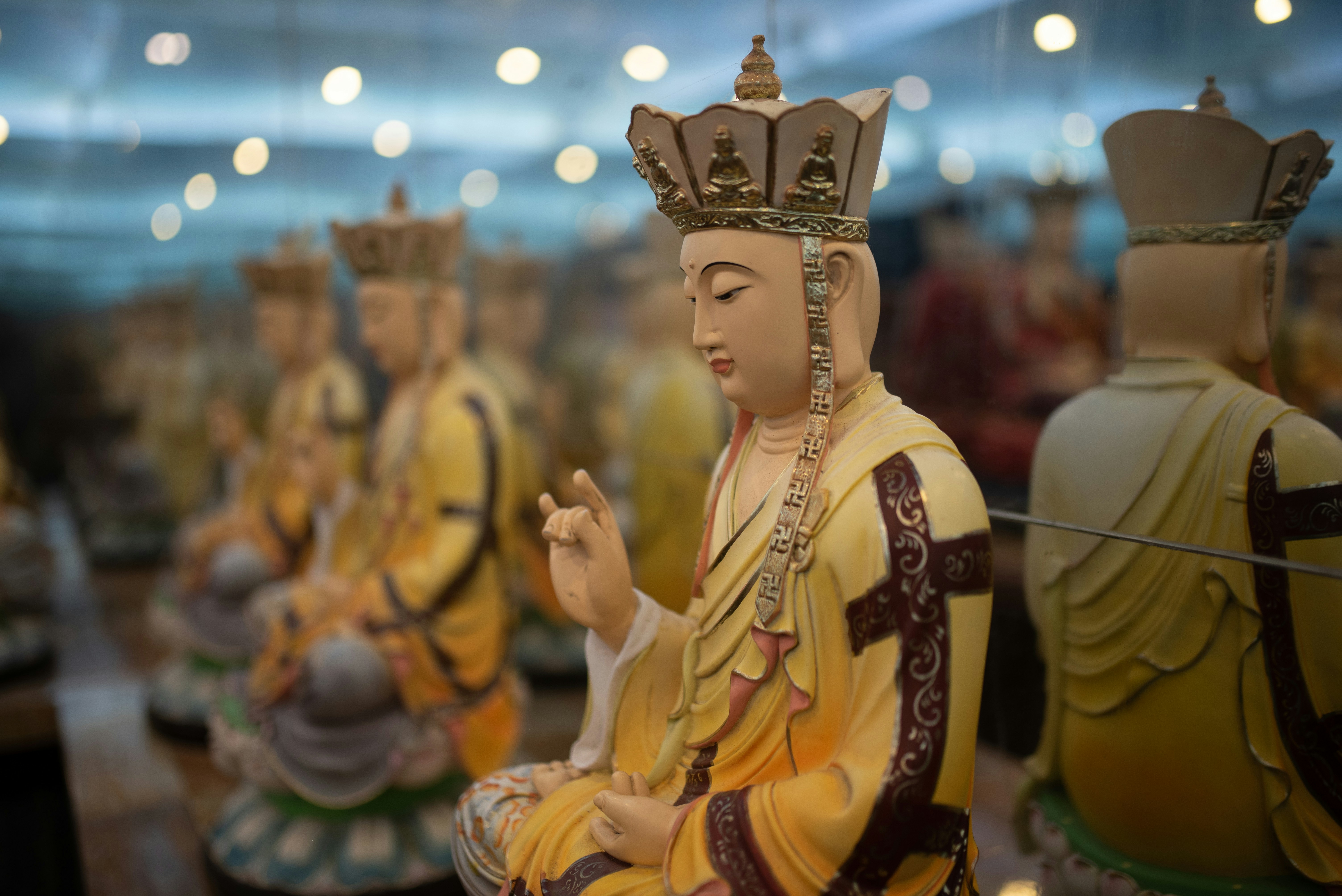 a group of statues of buddhas sitting next to each other