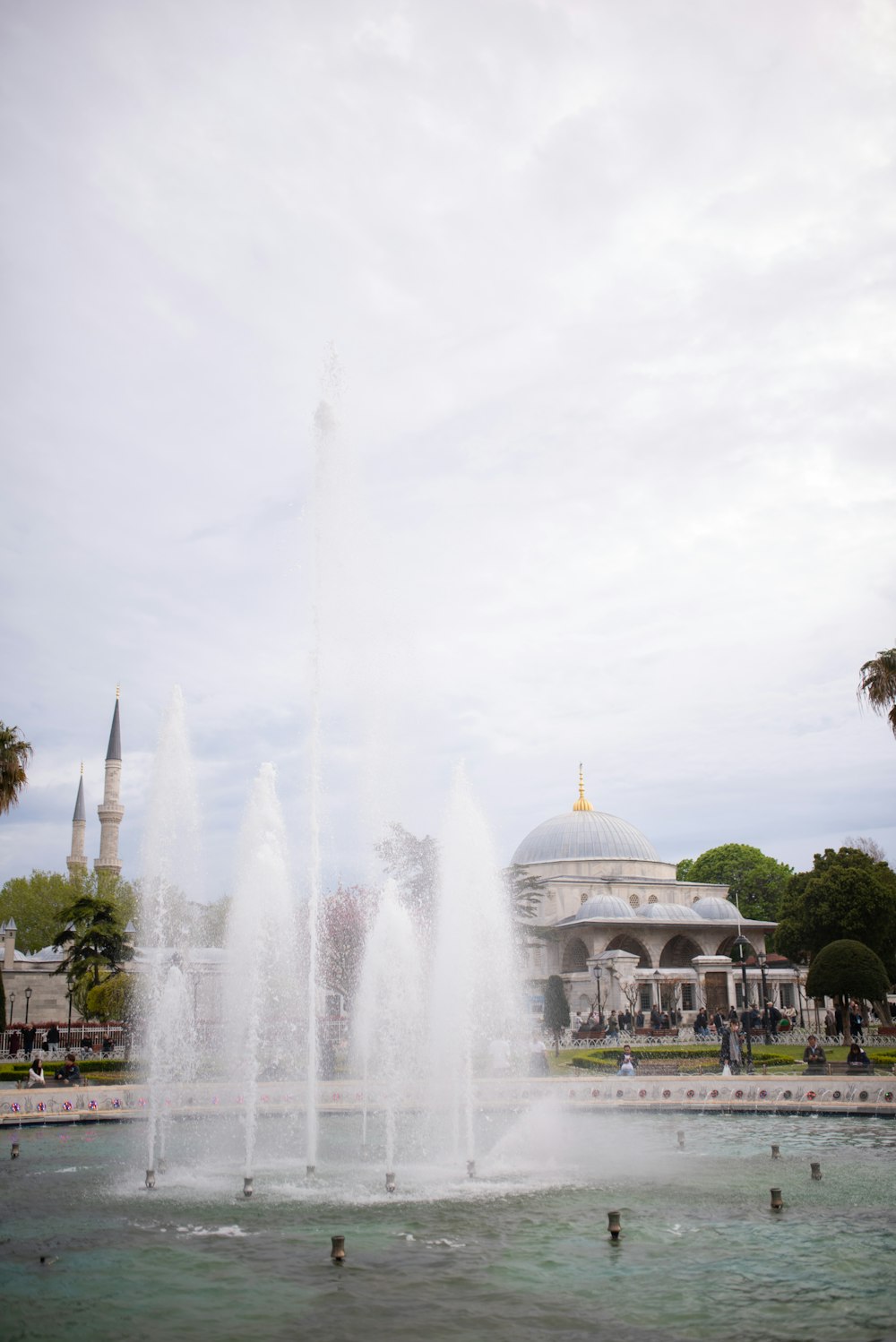 a water fountain in front of a large building