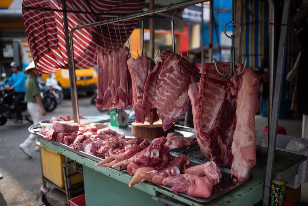a bunch of meat is being sold at a market