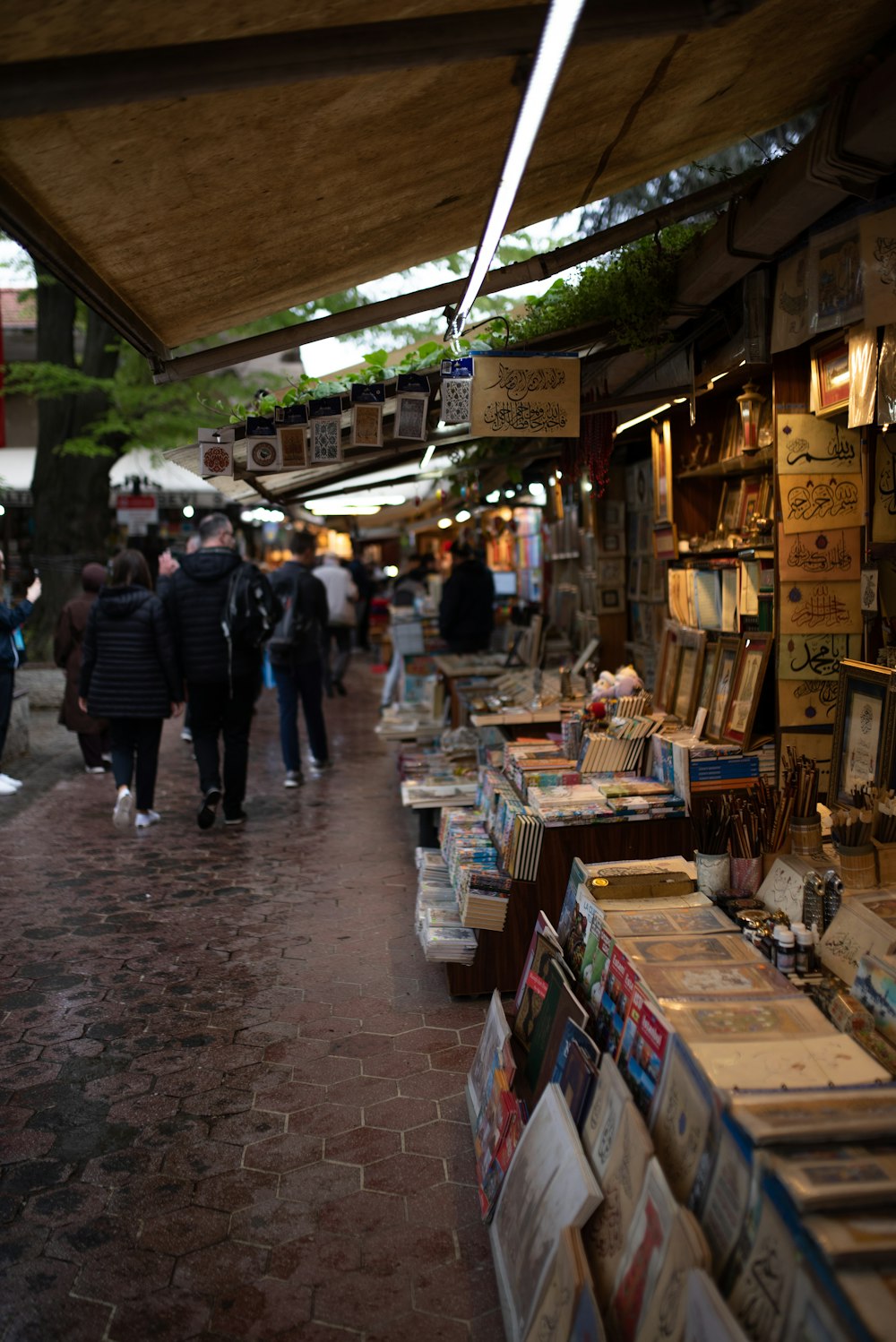 a group of people walking through a market