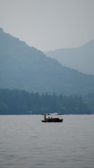 Guests enjoying boating on the serene Chilika Lake surrounded by nature.