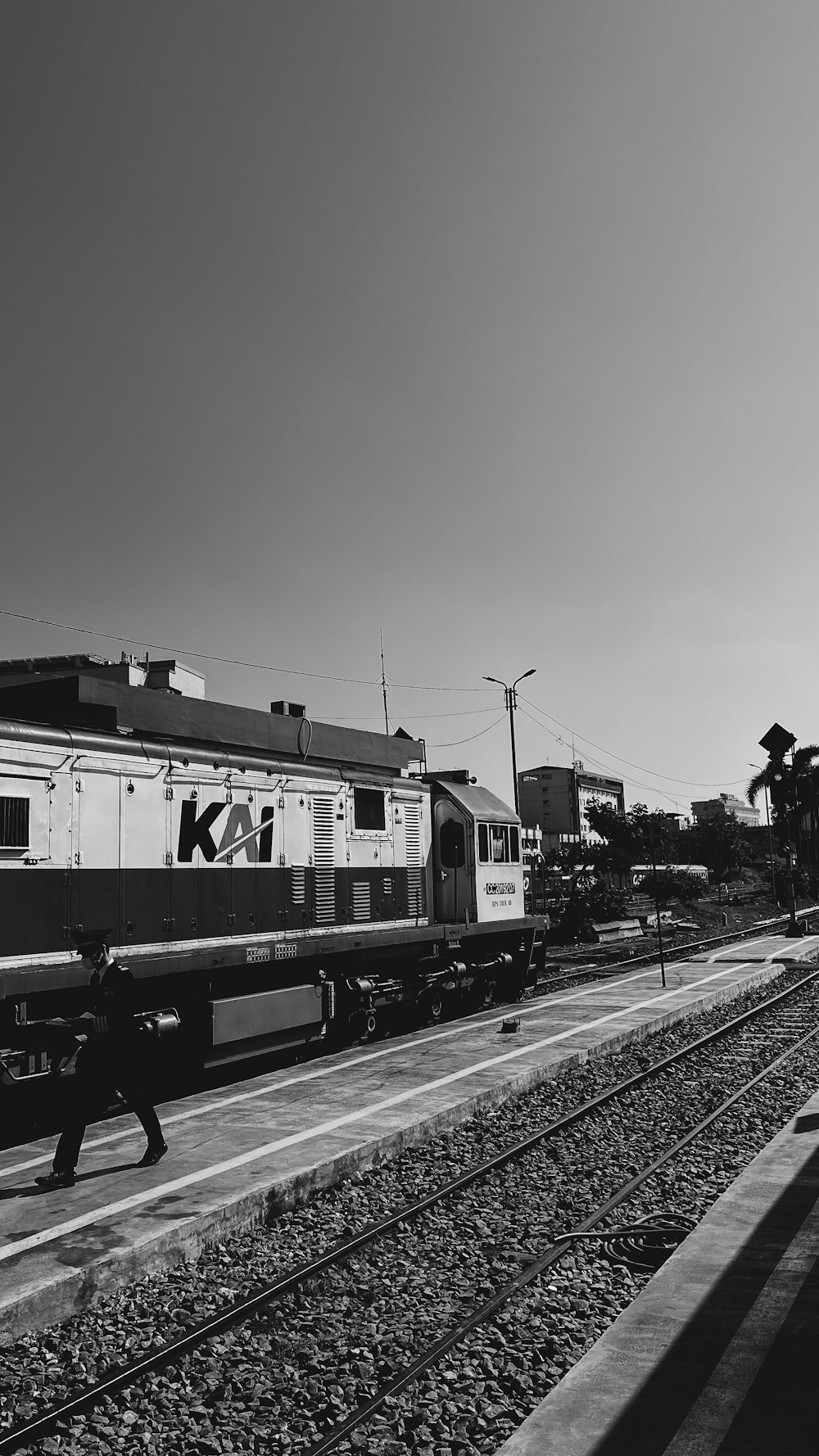 a black and white photo of a train on the tracks