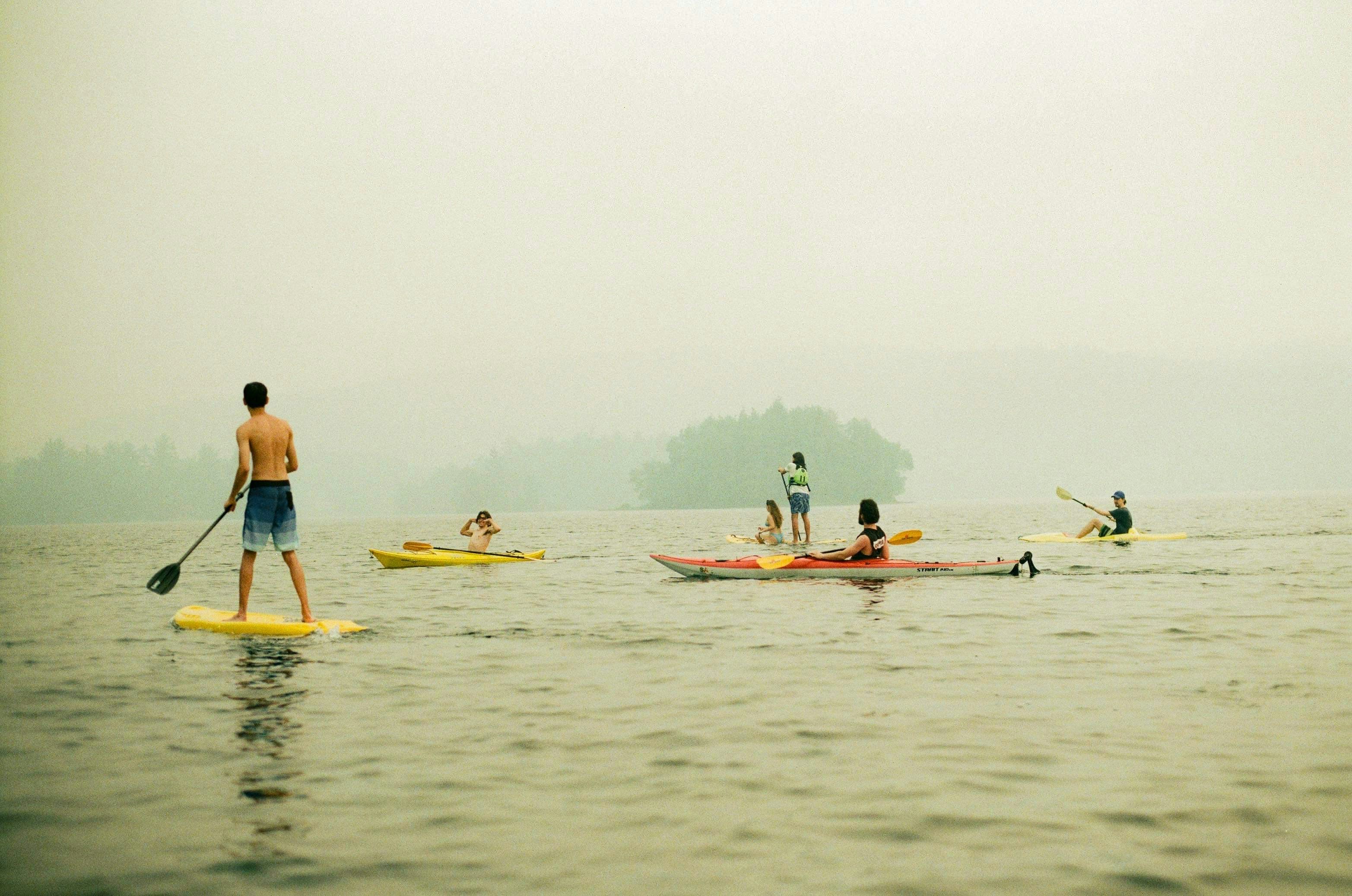 a group of people riding paddle boards on top of a body of water