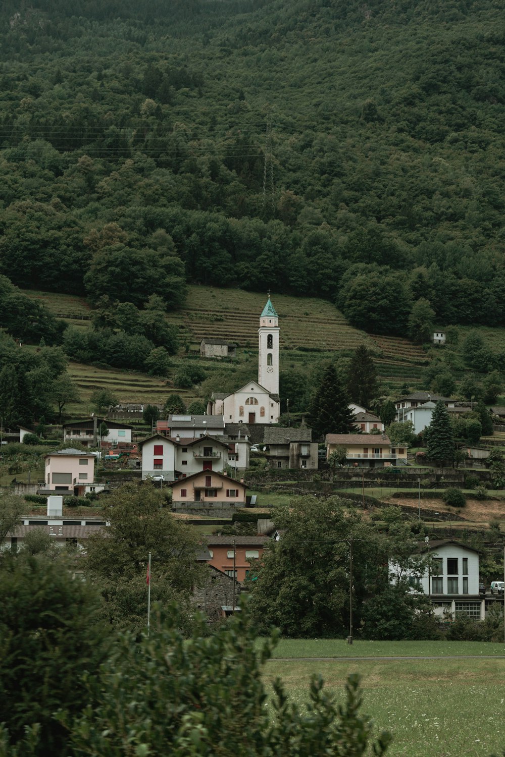 a small town with a steeple in the background