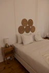 a bed with white sheets and pillows in a room