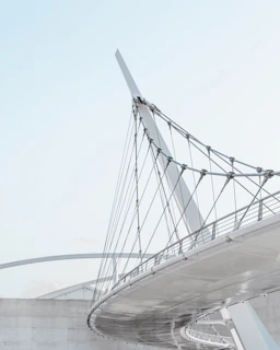 An innovative bridge design blending structural elegance with functional simplicity over a river.