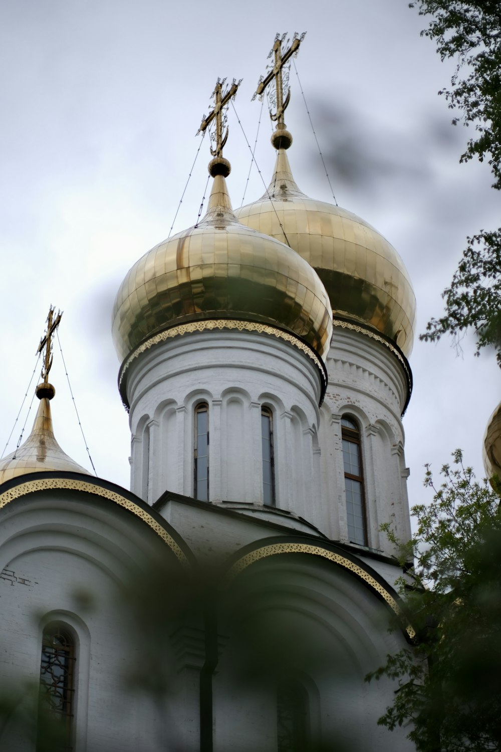 a large white building with two golden domes