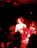 A joyful young girl performing on stage under warm spotlight.