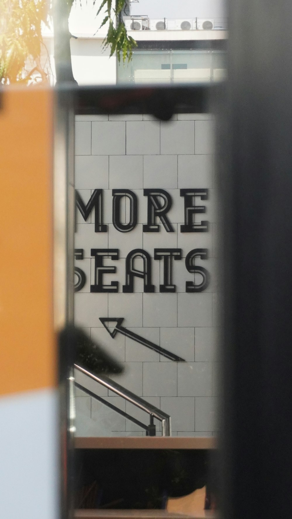 there is a sign that says more seats on the side of a building