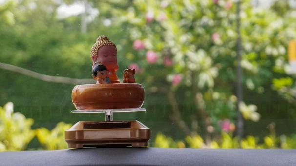 A serene display of nature-themed figurines nestled among tiny faux plants.