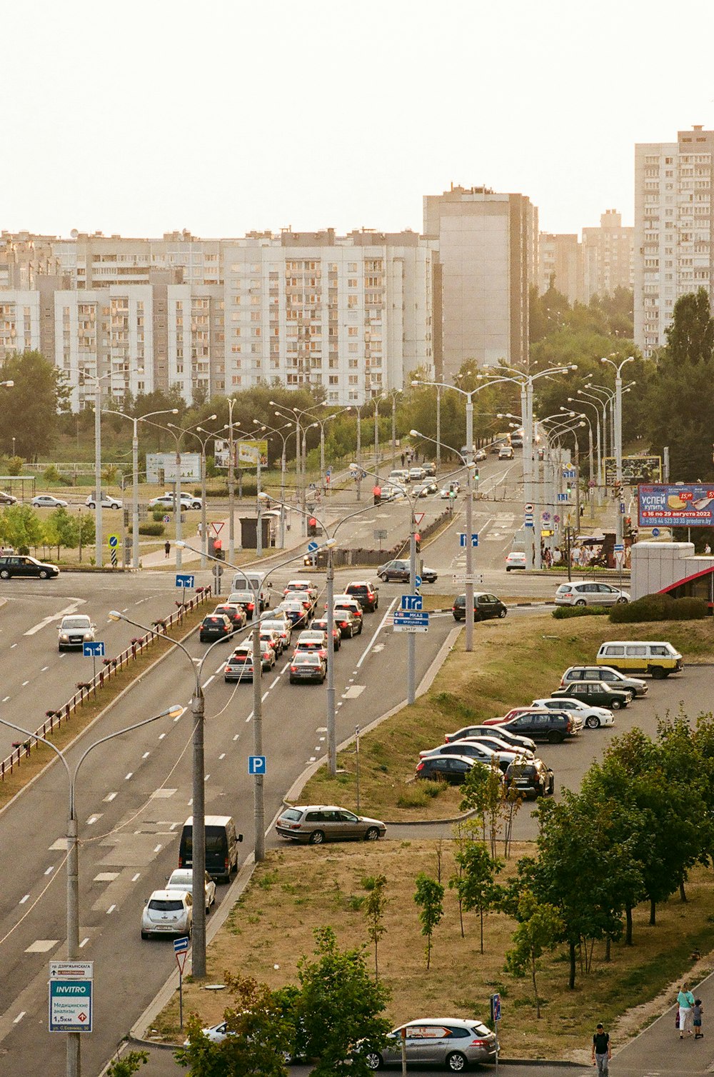 a city street filled with lots of traffic next to tall buildings